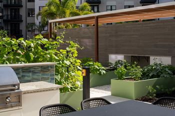 A patio with a grill and chairs